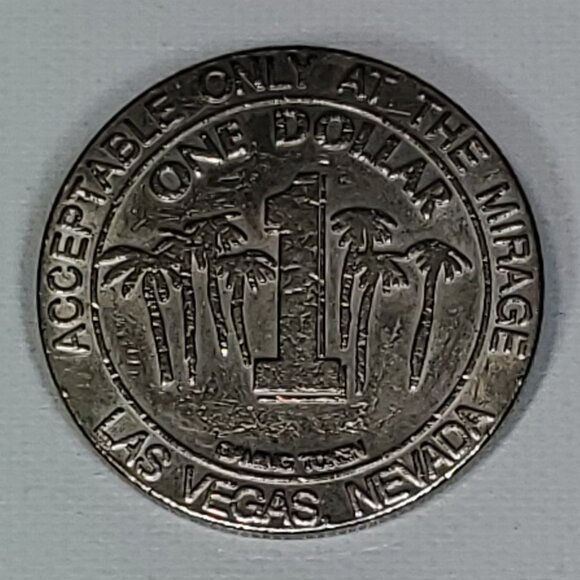 VINTAGE MIRAGE CASINO SILVER ONE DOLLAR GAMING TOKEN 1989 BY NEVADA COIN MINTING - Picture 2 of 4
